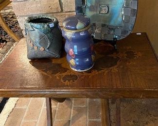 More great pottery on a folding antique table.