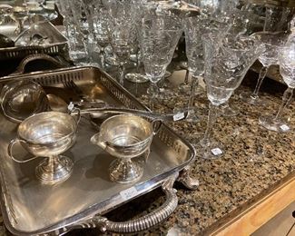 Multiple pieces of sterling and plate along with etched crystal stemware.