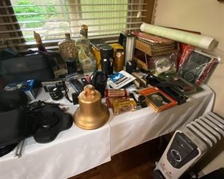 Cameras, books, old decanters, maps,