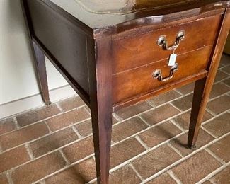 Leather top side table on small casters.