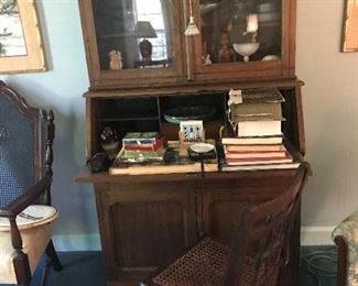 Secretary with wood carving and cane bottom chair
