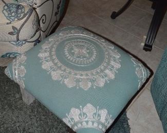 There are two of these padded footstools