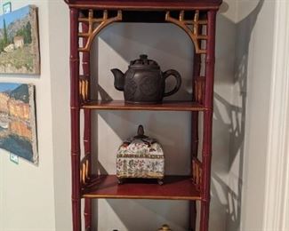 Hangin Chinese red wall shelf, with Asian teapot collection.