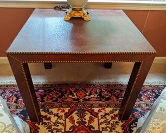 Faux ostrich skin table with brass nailheads.