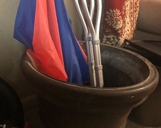 large outdoor pot, beach umbrella, crutches