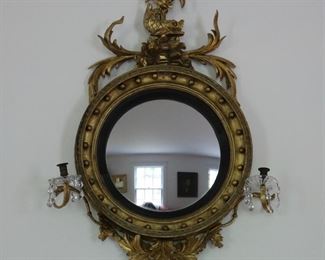 Exceptional antique bullseye mirror with dolphin carved crest and candles