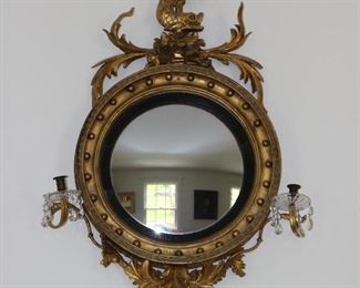 Exceptional antique bullseye mirror with dolphin carved crest and candles