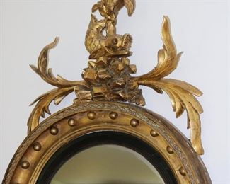 Exceptional antique bullseye mirror with dolphin carved crest and candles