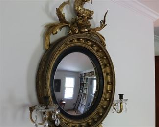 Exceptional antique bullseye mirror with dolphin carved crest and candles