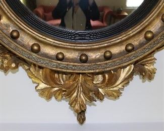 Exceptional antique bullseye mirror with dolphin carved crest and candles