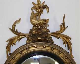 Exceptional antique bullseye mirror with dolphin carved crest and candles
