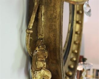 Exceptional antique bullseye mirror with dolphin carved crest and candles