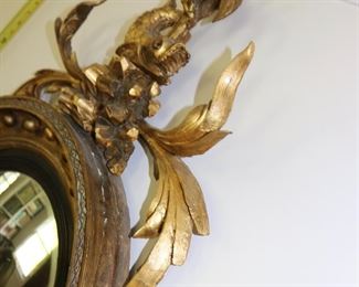 Exceptional antique bullseye mirror with dolphin carved crest and candles