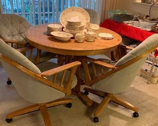 #26 - $100 - Oak Pedestal Table w/ 4 Rolling Chairs & 2 Leaves - 44"W x 44"D x 29"H