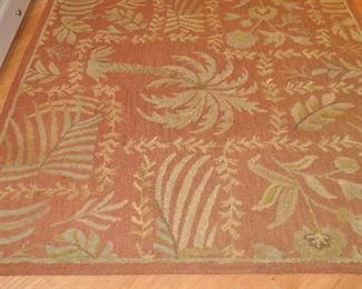 KALEEN 100% WOOL AREA RUG IN CINNAMON BASE WITH PALM TREES AND LEAF PATTERN, 5'9" X 5'9".  OUR PRICE IS $175.00.
