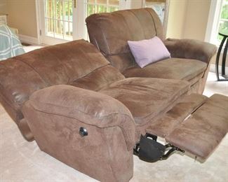 A VIEW OF THE SOFA FULLY RECLINED ON ONE SIDE.