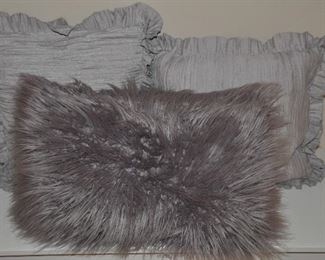 SET OF THREE GREY THROW PILLOWS - ONE LONG FUR, 25" X 16" AND TWO CREPE RUFFLED PILLOWS, 18" X 21".  OUR PRICE IS $40.00.
