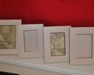 SET OF FOUR SOFT GREY LEATHER FRAMES, 3 FRAMES ARE FOR 4" X 6" AND ONE FRAME IS FOR 5" X 7".  OUR PRICE FOR THE SET IS $30.00. 