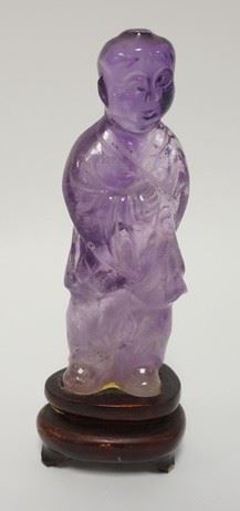 1006	AMETHYST STONE ASIAN FIGURE MOUNTED ON A WOODEN BASE, 5 1/2 IN HIGH
