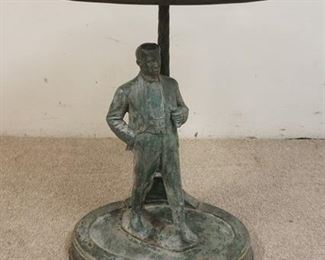 1020	FIGURAL TABLE WITH OVAL MARBLE TOP. METAL FIGURE OF A MAN ON A CAST IRON BASE. 26 IN X 18 1/2 IN, 28 IN HIGH. TOP IS LOOSE
