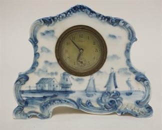1063	CHINA CASE DRESSER CLOCK W/ DELFT DECORATION, CLOCKWORKS ARE NEW HAVEN, 7 IN W, 5 5/8 IN H 
