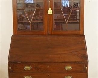 1105	MAHOGANY TWO PIECE SLANT FRONT SECRETARY HAS FOUR GRADUATED  DRAWERS IN THE BASE & TWO GLASS DOORS ON THE TOP,  34 3/4 X 84 1/4 
