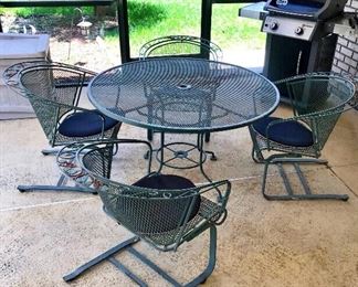 PRICE: $110.00   Iron Patio Table + 4 Chairs + PadsSolid Heavy Iron. Needs some paint Touch-Ups but is an excellent Vintage set 
Table: 48”Across • 27.5”T
Chairs: 29”T • 28”D •27”W
Item#67500
