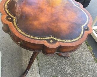 Item #65:  Antique mahogany drum table w/leather insert (very good condition-glare is sun bouncing off of it) w/drawers.  Apprx. 36".  rd. : $250