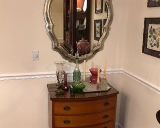 One of two pieces of Baker Furniture.  Baker Bachelor chest with vintage Princess silver leaf mirror, two pieces of French cutaway glass, one a rose bowl the other this green wine decanter, frosted Crystal candle flower wreath, antique green moon and stars pieces (has a slight glow under black light) and various vases