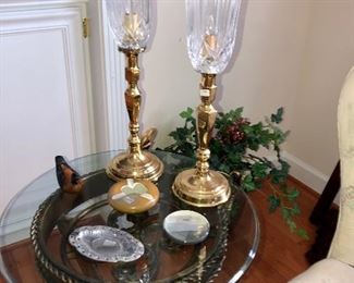 Pair of matching candlestick lamps, vintage ashtrays on a glass top wrought iron table  