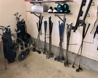 camping gear, ski equipment, luggage rack and several sets of golf clubS