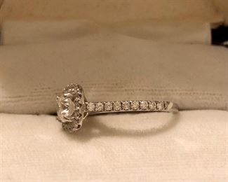 .70k center diamond, diamonds surrounding the diamond and band, engagement ring, with original paperwork 