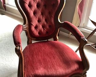 Antique Victorian arm chair with carved back.  Upholstery matches sofa and love seat