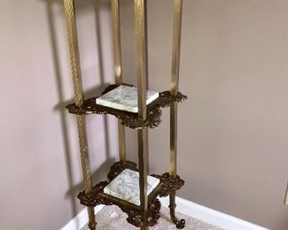 Cast metal three tier stand with marble insert shelves 