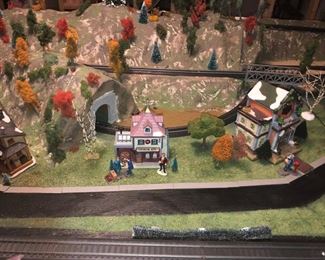 HO scale train display.  Utilizing Christmas village buildings for character and landscaping