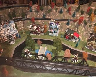 HO scale train display.  Utilizing Christmas village buildings for character and landscaping