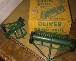 vintage Oliver grain drill and pull behind toy sickle or hay mowing machine. 