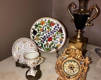 antique French styled metal clock, silver cup and saucer stand, plate