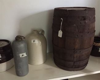 Stoneware and one of several wooden barrels.