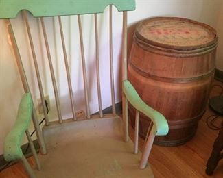 Rocking chair in vintage green paint and a Pillsbury flour wooden barrel.