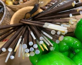 Chop sticks with mother of pearl caps.