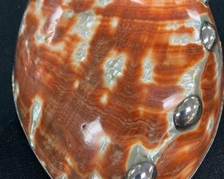 Top of abalone shell with silver accents.