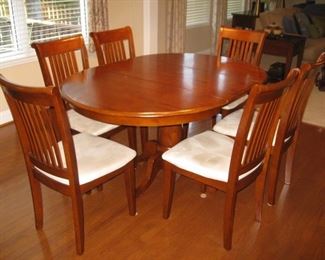 Kitchen table with 6 chairs. Leaf folds and stores in table top.