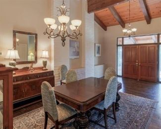 Dining Room: Grand Dining Table w Hand Turned Legs and Reupholstered Chairs, Sideboard, Lighted Curio, Table Lamps, Area Rug