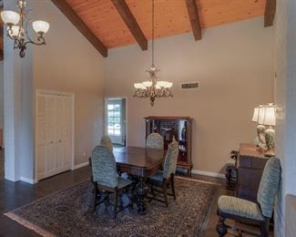 Dining Room: Grand Dining Table w Hand Turned Legs and Reupholstered Chairs, Sideboard, Lighted Curio, Table Lamps, Area Rug