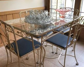 Glass topped wrought iron base table and 4 chairs