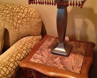 One of two silver lamps with beaded fringe on the lamp shade