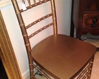 One of two gold side chairs