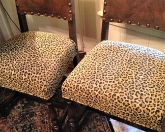 Two of four fabulous leopard print chairs with leather backs and nail head trim