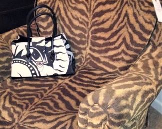 Club chair in brown and gold zebra stripe fabric; black & white purse